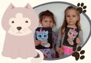 Sara i Natalka z pracą plastyczną- kolorowym kotem w ramce z kotem