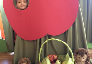 Nikola w fotobudce z jabłkiem.