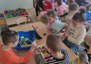 Dzieci budują pojazd w grupach przy pomocy aplikacji